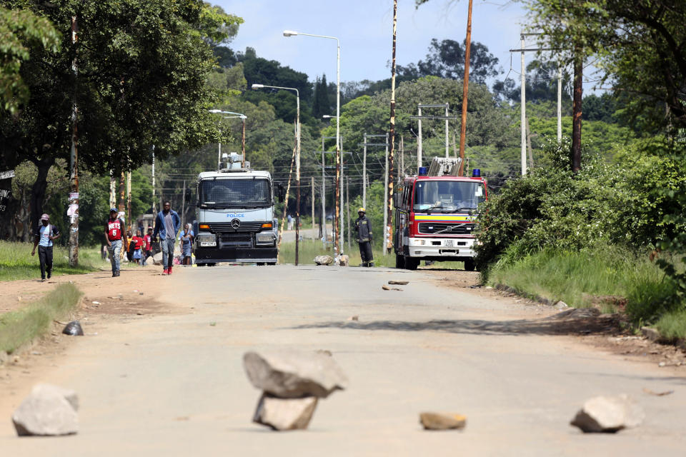 A police water cannon and fire engine during demonstrations over the hike in fuel prices in Harare, Zimbabwe, Monday, Jan. 14, 2019. Protesters have blocked roads in some parts in Zimbabwe's capital after the government more than doubled the price of gasoline. (AP Photo/Tsvangirayi Mukwazhi)