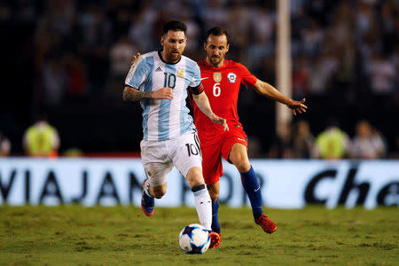 Football Soccer - Argentina v Chile - World Cup 2018 Qualifiers - Antonio Liberti Stadium, Buenos Aires, Argentina - 23/3/17 - Argentina's Lionel Messi (L) and Chile's Jose Pedro Fuenzalida in action. REUTERS/Martin Acosta