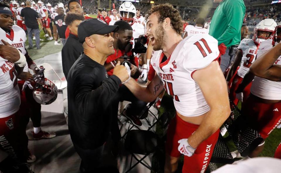 N.C. State defensive coordinator Tony Gibson congratulates Payton Wilson (11) after he intercepted the ball during the Wolfpack’s 24-14 victory over UConn at Rentschler Field in East Hartford, Conn. Thursday, August 31, 2023.