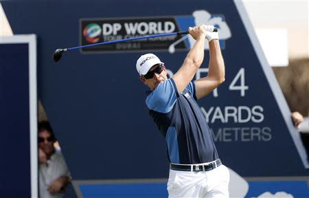 Henrik Stenson of Sweden tees off on the first hole during the first round of the DP World Tour Championship gold tournament in Dubai November 14, 2013. REUTERS/Ahmed Jadallah