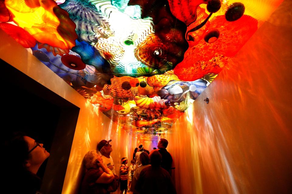 People walk under the "Persian Ceiling" in the Dale Chihuly exhibit during free family day at the Oklahoma City Museum of Art, Sunday, Sept. 7, 2014.