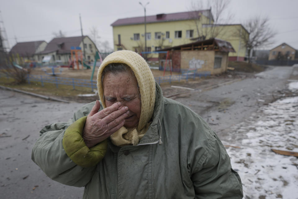 A woman cries outside houses damaged by a Russian airstrike, according to locals, in Gorenka, outside the capital Kyiv, Ukraine, Wednesday, March 2, 2022. Russia renewed its assault on Ukraine's second-largest city in a pounding that lit up the skyline with balls of fire over populated areas, even as both sides said they were ready to resume talks aimed at stopping the new devastating war in Europe. (AP Photo/Vadim Ghirda)