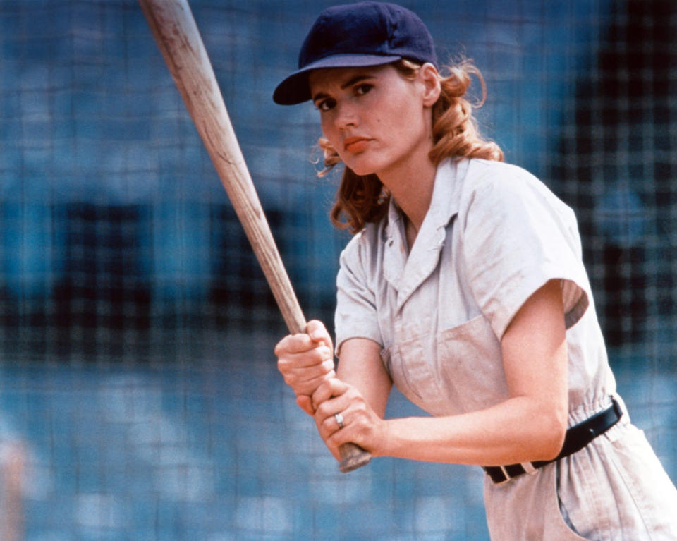 Geena Davis holding a bat.