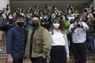 Hong Kong activists, from left, Joshua Wong, Ivan Lam and Agnes Chow arrive at a court in Hong Kong, Monday, Nov. 22. 2020. The trio appear at court for their trial as they faces charges related to the besieging of a police station during anti-government protests last year. (AP Photo/Vincent Yu)