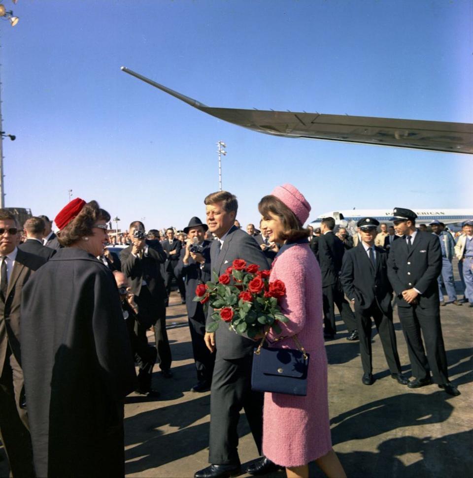 Former First Lady Jackie Kennedy receives red roses shortly before JFK’s assassination in Dallas, Texas. <a href="https://www.jfklibrary.org/asset-viewer/archives/JFKWHP/1963/Month%2011/Day%2022/JFKWHP-1963-11-22-B?image_identifier=JFKWHP-ST-C420-13-63" rel="nofollow noopener" target="_blank" data-ylk="slk:Cecil Stoughton. White House Photographs. John F. Kennedy Presidential Library and Museum, Boston;elm:context_link;itc:0;sec:content-canvas" class="link ">Cecil Stoughton. White House Photographs. John F. Kennedy Presidential Library and Museum, Boston</a>