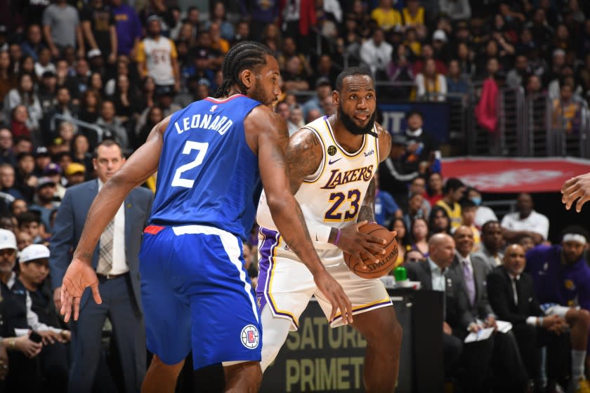 Clippers' Kawhi Leonard plays defense against Lakers' LeBron James on March 8 at Staples Center