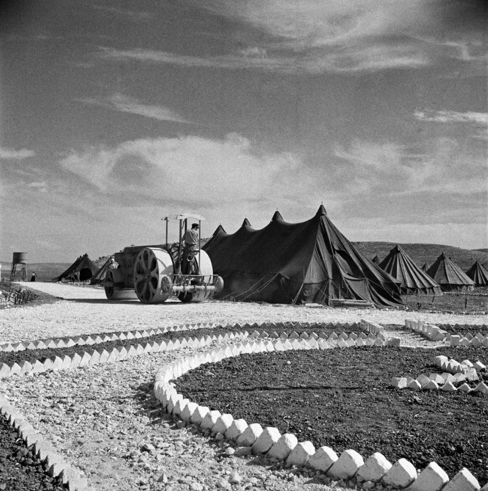 In this undated photo from the U.N. Relief and Works Agency, UNRWA, archive, a steam roller over the "streets" of Janzur refugee camp near Jenin in the West Bank, which was organized by the International Committee of the Red Cross. The photo is part of UNWRA's vast photo archive being digitized in Gaza and Denmark to preserve a record of one of the world's most entrenched refugee problems, created in what the Palestinians call the "Nakba," or “catastrophe”-- their uprooting in the war over Israel's 1948 creation. (AP Photo/UNRWA Photo Archives)