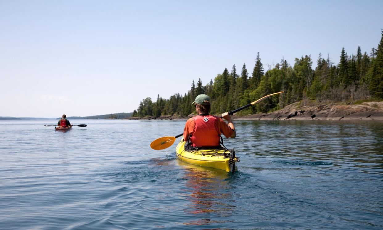 <span>A person kayaks in the middle of Lake Superior in Michigan.</span><span>Photograph: Per Breiehagen/Getty Images</span>