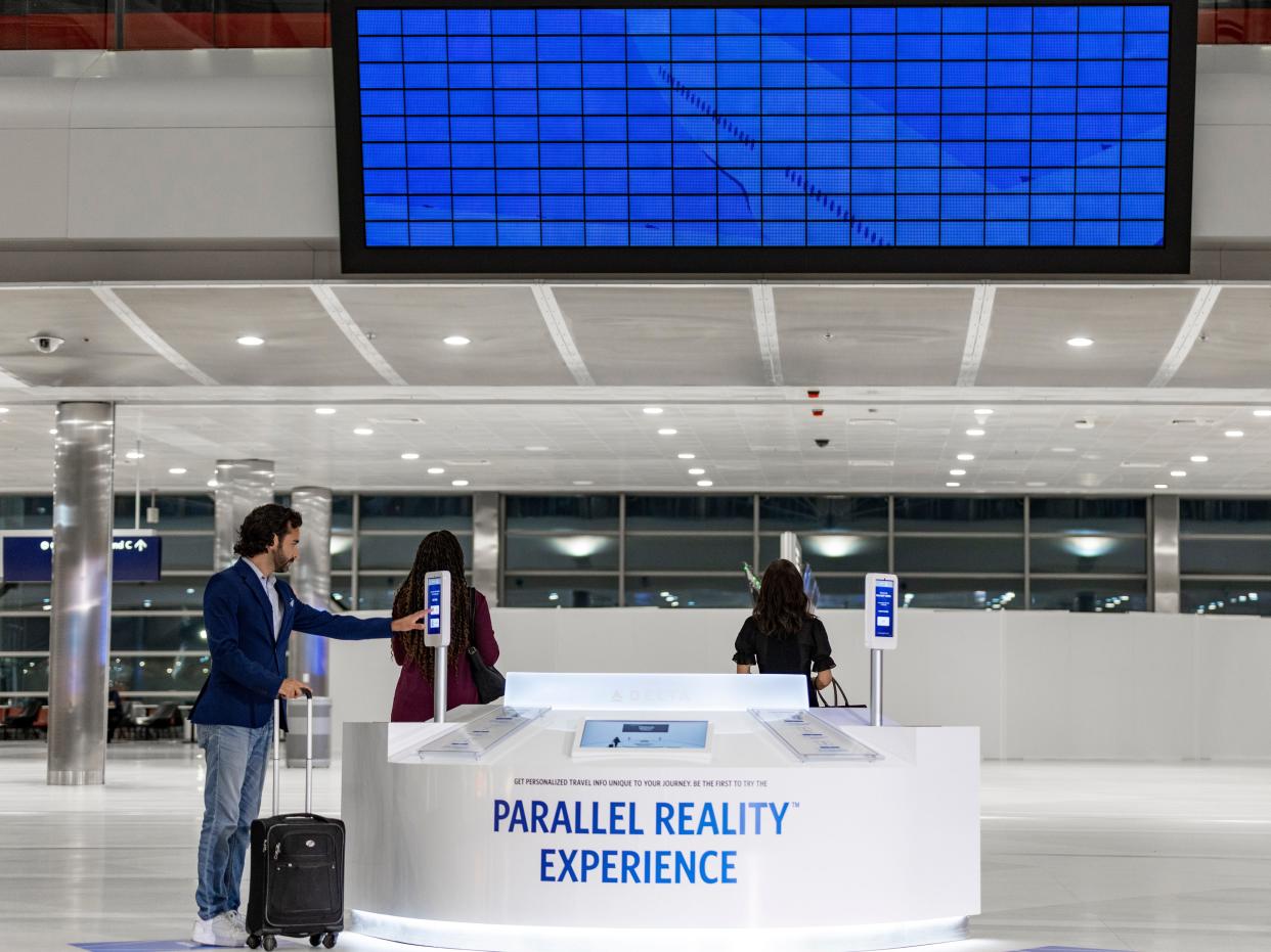 A "Parallel Reality Experience" kiosk is shown at the Detroit airport.