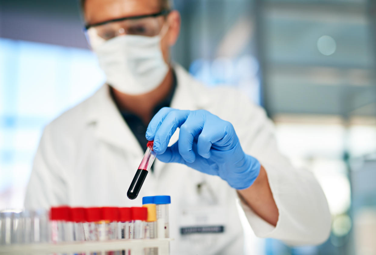 Cropped shot of a male doctor working with blood samples in his lab