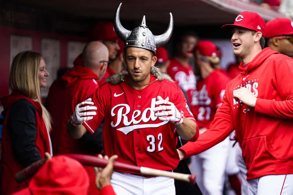 Cincinnati Reds' Jason Vosler (32) celebrates with teammates after hitting a solo home run against the Pittsburgh Pirates in the second inning of a baseball game in Cincinnati, Sunday, April 2, 2023. (AP Photo/Jeff Dean)