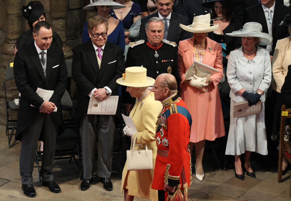 The Queen and Prince Philip head to their seats as Elton John looks on