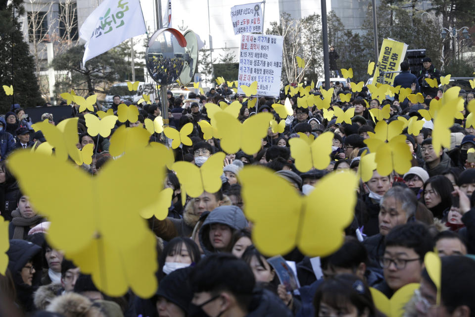 Mourners hold yellow butterfly cutouts dedicated to Kim Bok-dong, a former South Korean sex slave, during her funeral ceremony in front of the Japanese Embassy in Seoul, South Korea, Friday, Feb. 1, 2019. Hundreds of mourners gathered Friday near the embassy for the funeral of Kim forced as a girl into a brothel and sexually enslaved by the Japanese military in WWII. (AP Photo/Ahn Young-joon)