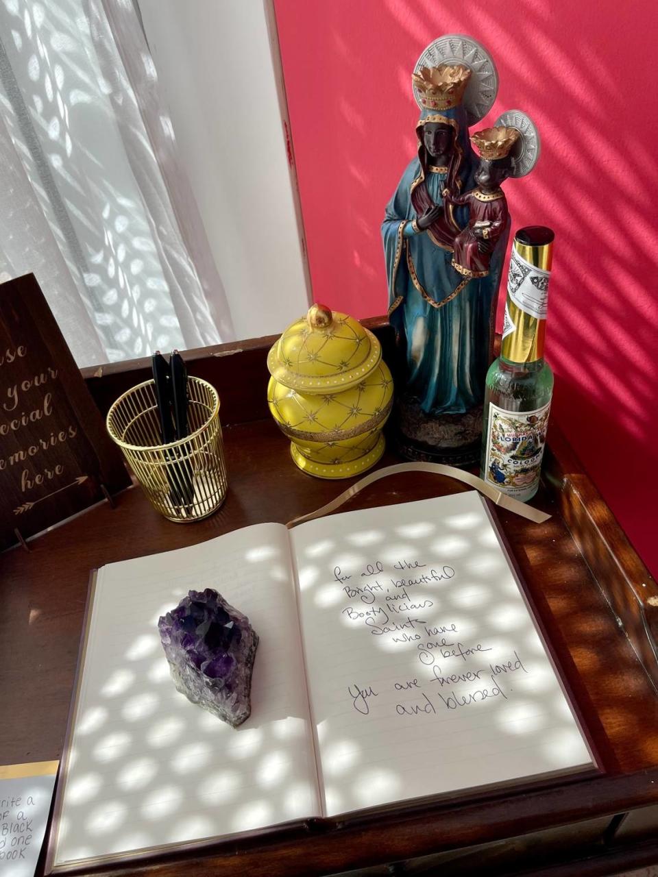 A remembrance book lays open in “The Repast” section of “Give Them Their Flowers,” an exhibition on Miami’s Black LGBTQ history in Little Haiti. Visitors are invited to leave messages honoring deceased Black queer loved ones.