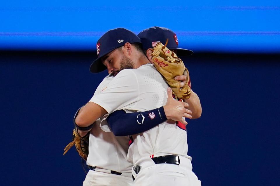 United States' Eddy Alvarez, front, and Nick Allen embrace after a semi-final baseball game against South Korea at the 2020 Summer Olympics, Thursday, Aug. 5, 2021, in Yokohama, Japan. The United States won 7-2. 