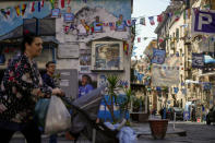 Banners and writings in support of Napoli soccer team are displayed in downtown Naples, Italy, Wednesday, April 19, 2023. It's a celebration more than 30 years in the making, and historically superstitious Napoli fans are already painting the city blue in anticipation of the team's first Italian league title since the days when Diego Maradona played for the club. (AP Photo/Andrew Medichini)