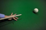Three-year-old Wang Wuka plays a shot during snooker practice at his home in Xuancheng, Anhui province, September 13, 2013. (REUTERS/Stringer)