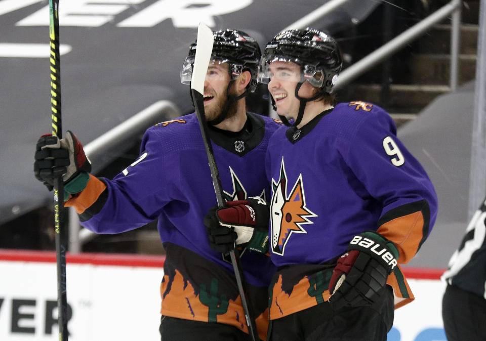 Arizona Coyotes' Jordan Oesterle (82) celebrates with Clayton Keller (9) after he scored against the Colorado Avalanche during the second period of an NHL hockey game Saturday, Feb. 27, 2021, in Glendale, Ariz. (AP Photo/Darryl Webb)