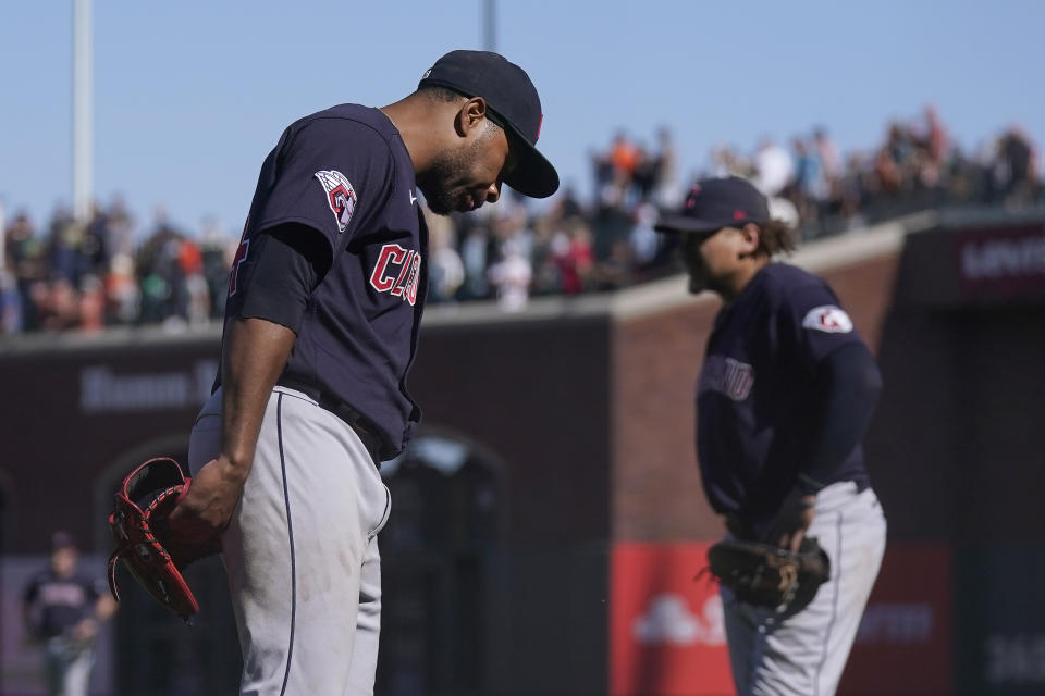 Cleveland Guardians pitcher Xzavion Curry, left, waits on the field for a replay challenge after San Francisco Giants' LaMonte Wade Jr. hit a sacrifice fly that scored Patrick Bailey for the winning run during the tenth inning of a baseball game in San Francisco, Wednesday, Sept. 13, 2023. The call on the field was upheld. (AP Photo/Jeff Chiu)