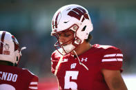 Wisconsin quarterback Graham Mertz (5) talks to running back Isaac Guerendo (20) during the first half of an NCAA college football game against Illinois, Saturday, Oct. 1, 2022, in Madison, Wis. (AP Photo/Kayla Wolf)