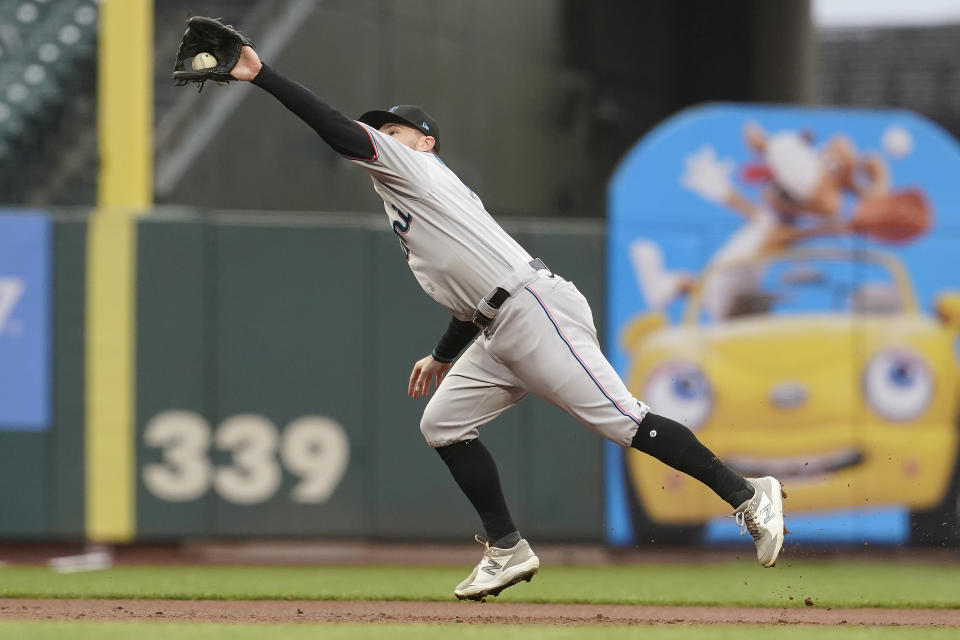 Miami Marlins third baseman Jon Berti fields a line-out hit into San Francisco Giants' Wilmer Flores during the first inning of a baseball game in San Francisco, Thursday, April 22, 2021. (AP Photo/Jeff Chiu)