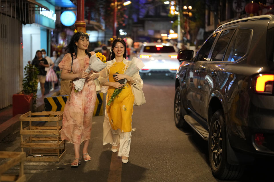 Vietnamese tourists walk at Binondo district, said to be the oldest Chinatown in the world, in Manila, Philippines on Tuesday, Feb. 6, 2024. Crowds are flocking to Manila's Chinatown to usher in the Year of the Wood Dragon and experience lively traditional dances on lantern-lit streets with food, lucky charms and prayers for good fortune. (AP Photo/Aaron Favila)