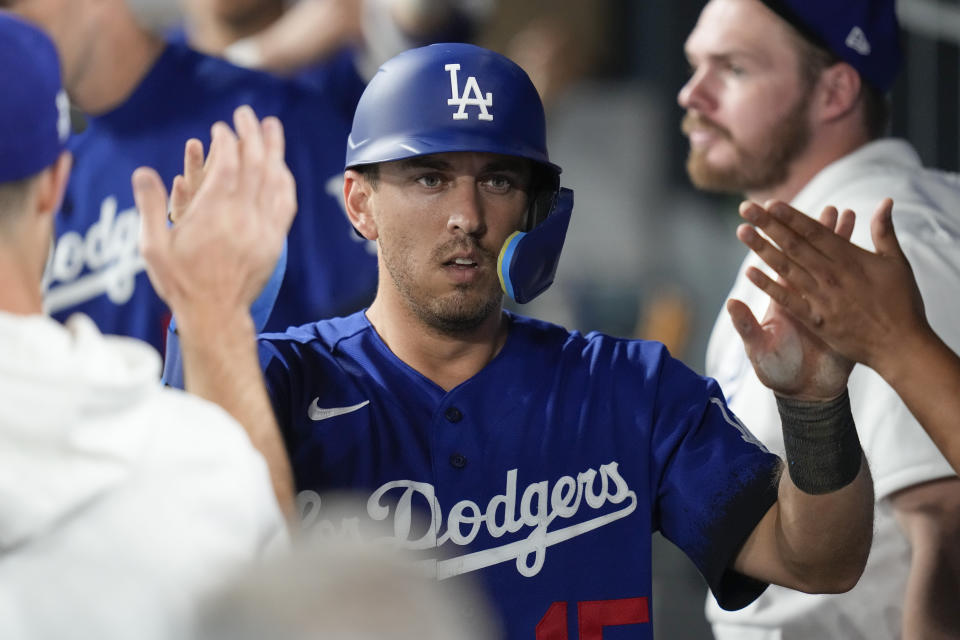 Los Angeles Dodgers' Austin Barnes (15) celebrates in the dugout after scoring off of a single hit by Will Smith during the sixth inning of a baseball game against the Oakland Athletics in Los Angeles, Thursday, Aug. 3, 2023. (AP Photo/Ashley Landis)