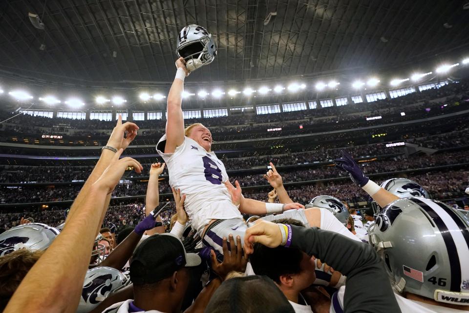 Kansas State's Ty Zentner (8) is lifted up by his teammates after hitting the game winning field goal in overtime of the Big 12 Conference championship against TCU on Saturday in Arlington, Texas.