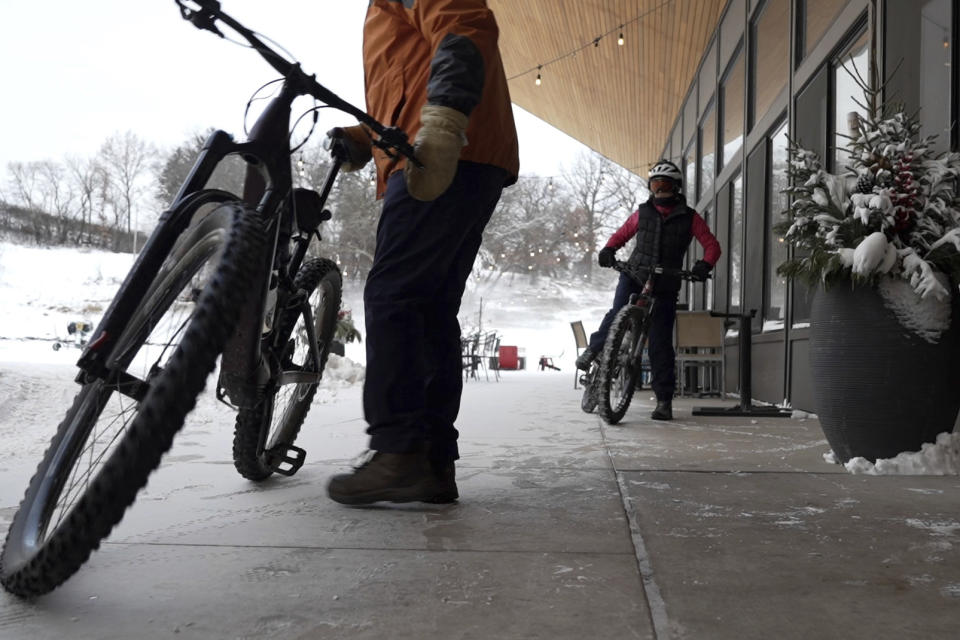 Winter fat bikers prepare to hit the trails at Theodore Wirth Park on Thursday, Jan. 18, 2024 in Minneapolis, Minn. As a bout of bitter and deadly cold sweeps the U.S., millions of Americans are being told to dress in layers if they must go outside. (AP Photo/Mark Vancleave)