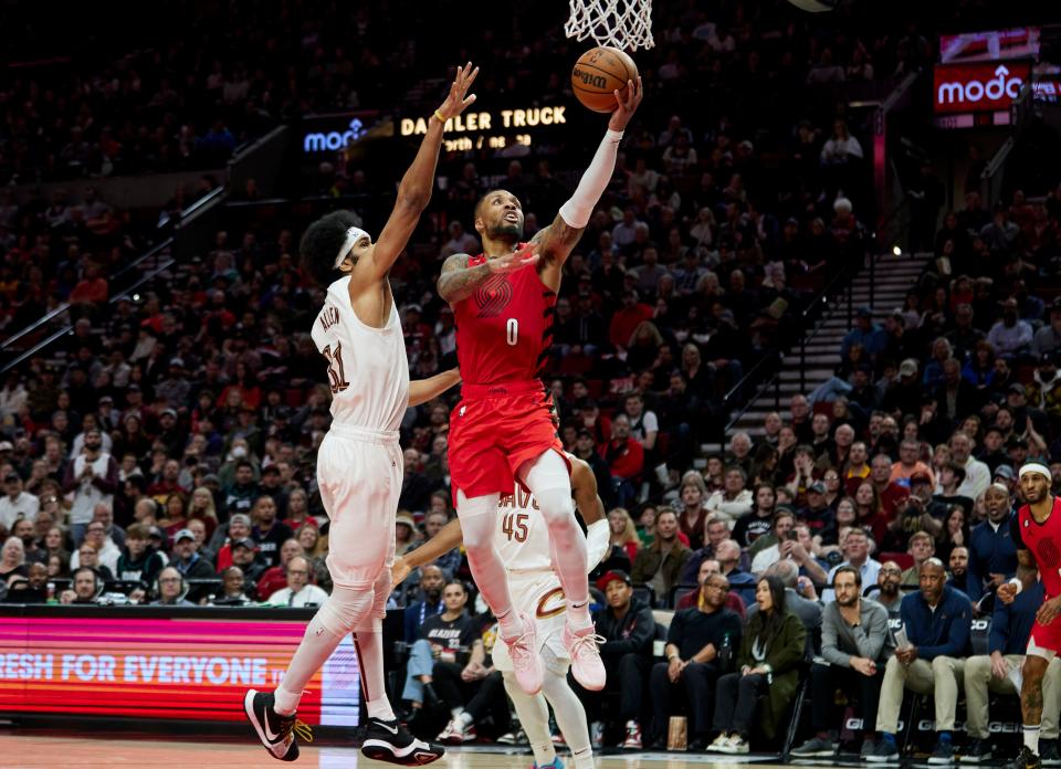 Portland Trail Blazers guard Damian Lillard, right, shoots in front of Cleveland Cavaliers center Jarrett Allen during the second half of an NBA basketball game in Portland, Ore., Thursday, Jan. 12, 2023. (AP Photo/Craig Mitchelldyer)