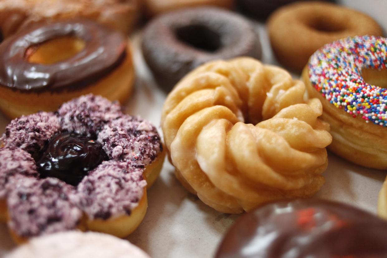 In this July 22, 2009 file photo, Tim Hortons' doughnuts are lined up in a box in New York. The new Tim Hortons Rewards redemption program will be getting a major update in February 2023. (AP Photo/Seth Wenig, File)