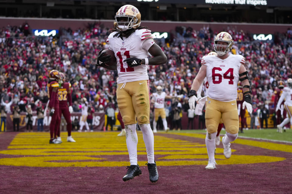 San Francisco 49ers wide receiver Brandon Aiyuk (11) celebrating scoring a touchdown against the Washington Commanders during the second half of an NFL football game, Sunday, Dec. 31, 2023, in Landover, Md. San Francisco won 27-10. (AP Photo/Alex Brandon)