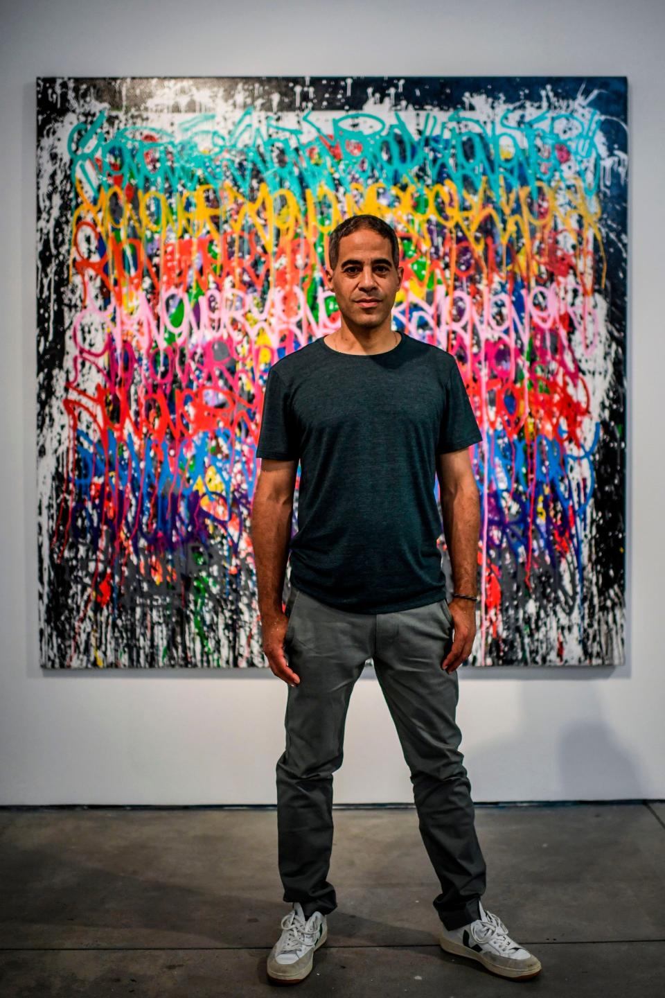 Graffiti artist JonOne, pictured here with another one of his works.