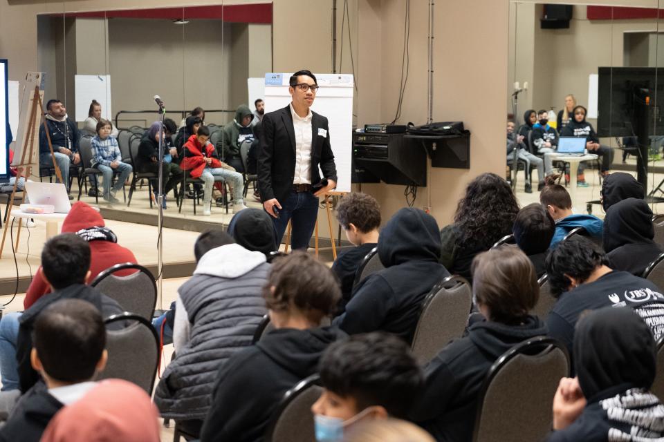 Eddie Noriega, a vice president of the Latino Professionals Association of Northeast Wisconsin, speaks to Green Bay students at the Latino Achievement Summit on March 9, 2022.