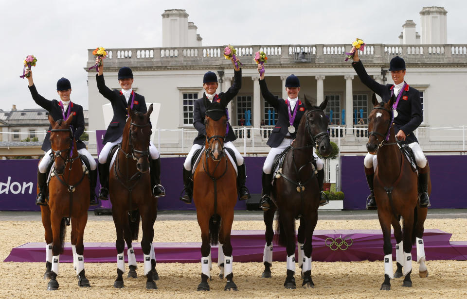 (L-R) Britain's Zara Phillips, Kristina Cook, Mary King, Nicola Wilson and William Fox-Pitt pose on their horses after receiving their silver medals in the Eventing Team Jumping equestrian event victory ceremony at the London 2012 Olympic Games in Greenwich Park, July 31, 2012. REUTERS/Eddie Keogh (BRITAIN - Tags: SPORT OLYMPICS EQUESTRIANISM) 