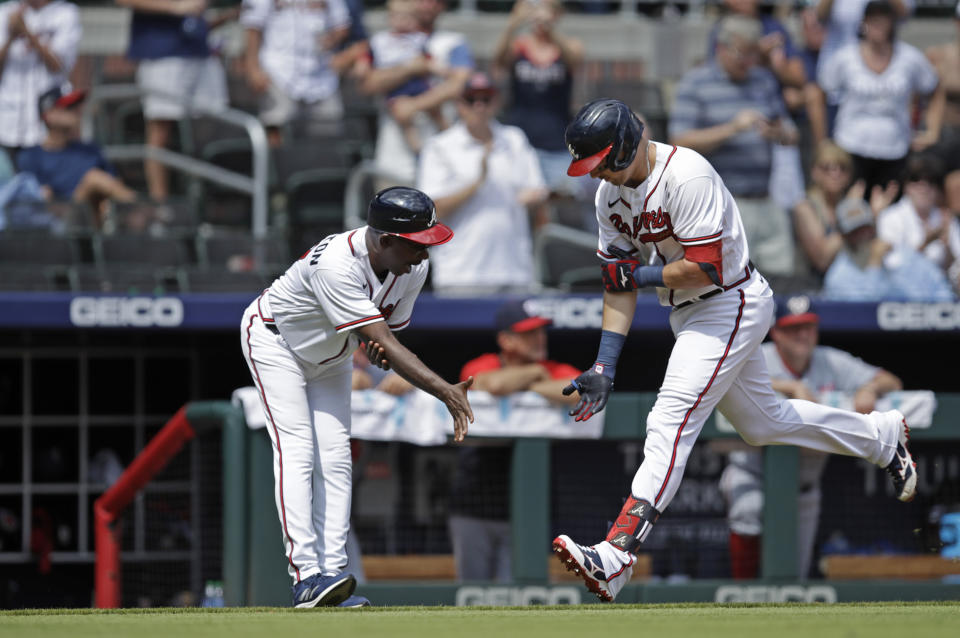 Atlanta Braves' Austin Riley, right, celebrates with third base coach Ron Washington after hitting a home run against the Washington Nationals in the eighth inning of a baseball game, Sunday, July 10, 2022, in Atlanta. (AP Photo/Ben Margot)