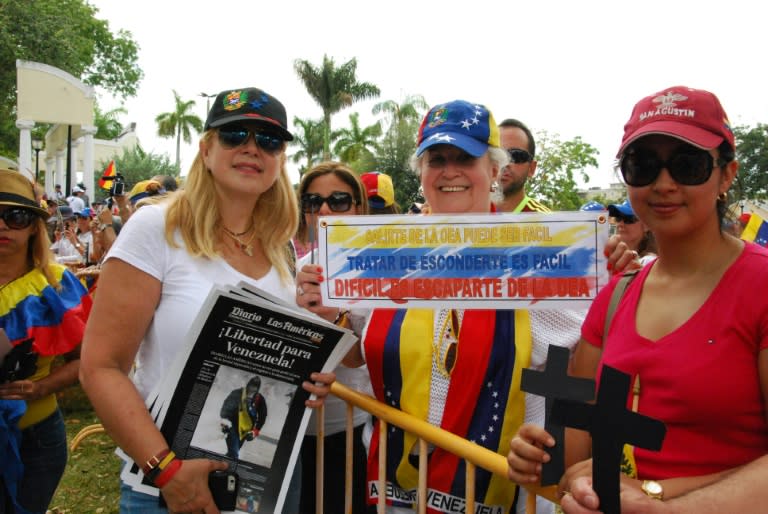 Carolina Perpetuo, left, attends a rally in Miami to support protesters back home in Venezuela