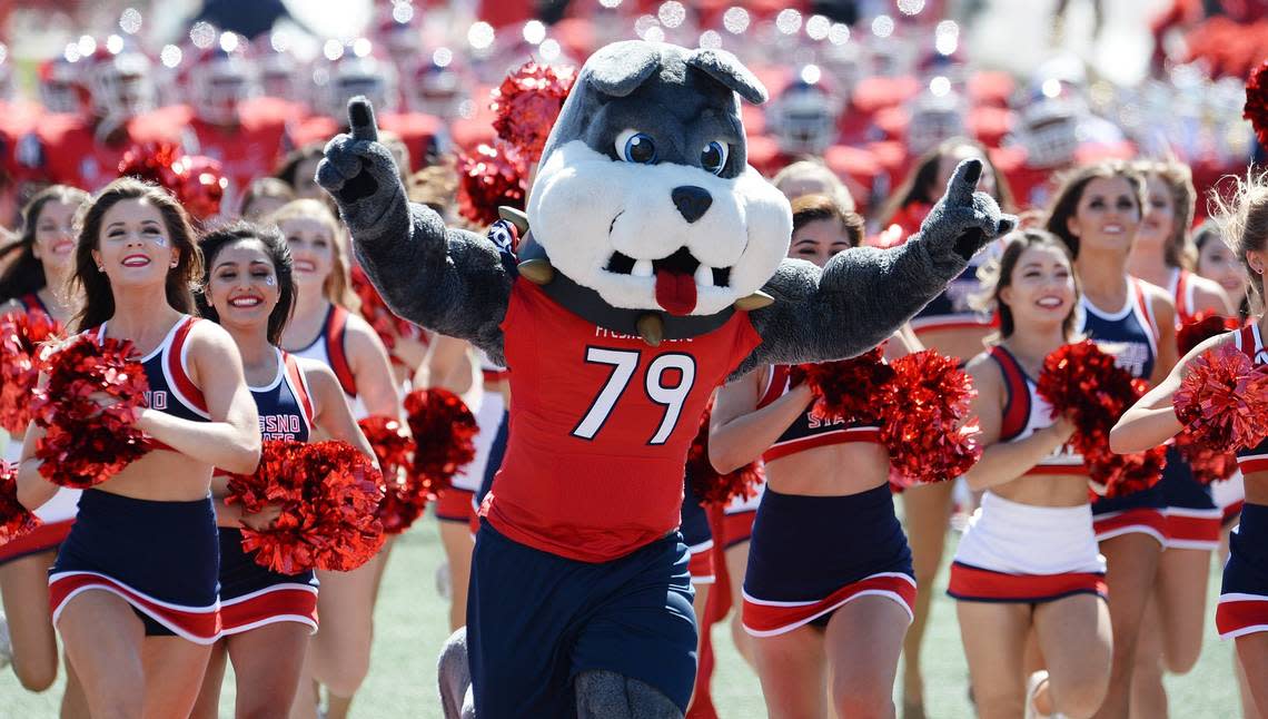 Timeout, the Fresno State mascot runs onto the field with Bulldog cheerleaders before the start of their game against Tulsa at Bulldog Stadium in Fresno, Saturday, Sept. 24, 2016.