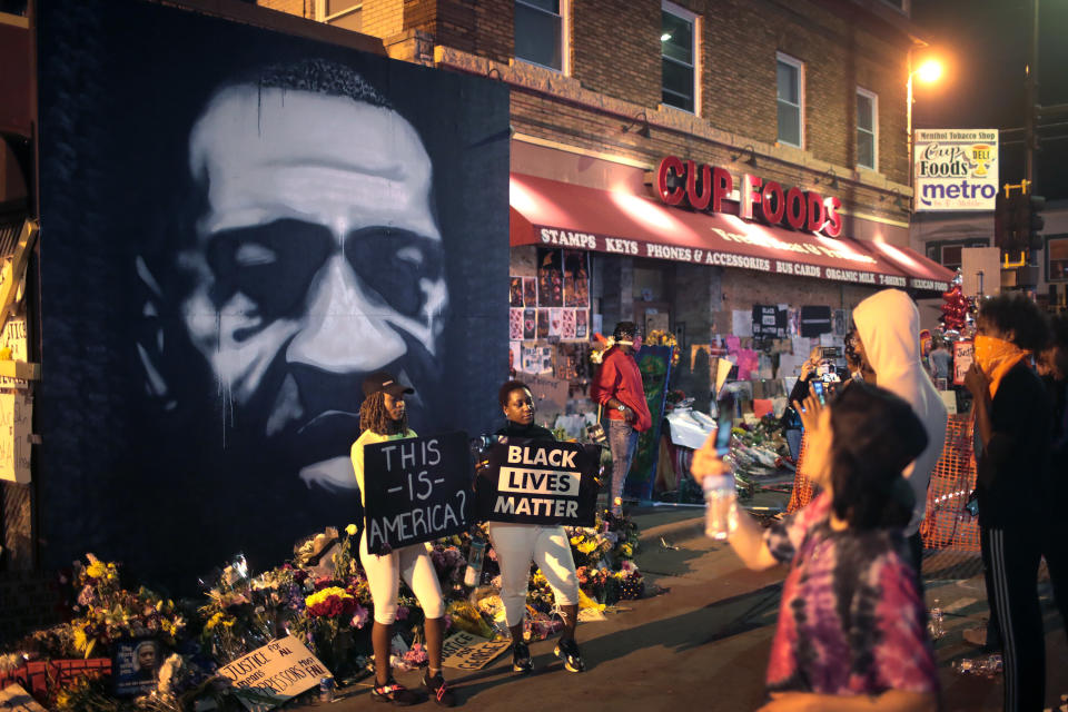 People visit a memorial at the site where George Floyd was killed on June 3, 2020, in Minneapolis.