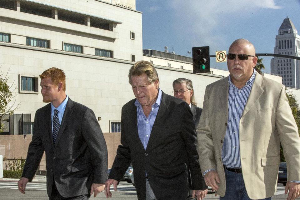 Redmond O'Neal, left, Ryan O'Neal, center, and an unidentified man leave court for a lunch break on Thursday, Dec. 12, 2013, in Los Angles. Attorneys for O’Neal concluded their case in the actor’s bid to keep a version of an Andy Warhol portrait of his longtime partner Farrah Fawcett. The former couple’s son Redmond O’Neal was among the final witnesses. (AP Photo/Damian Dovarganes)