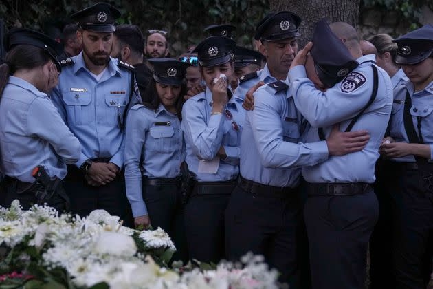 Israeli police officers weep for their slain colleague: one of five killed by a Palestinian gunman in a crowded city in central Israel late Tuesday, the second mass shooting rampage this week. (AP Photo/Ariel Schalit) (Photo: via Associated Press)