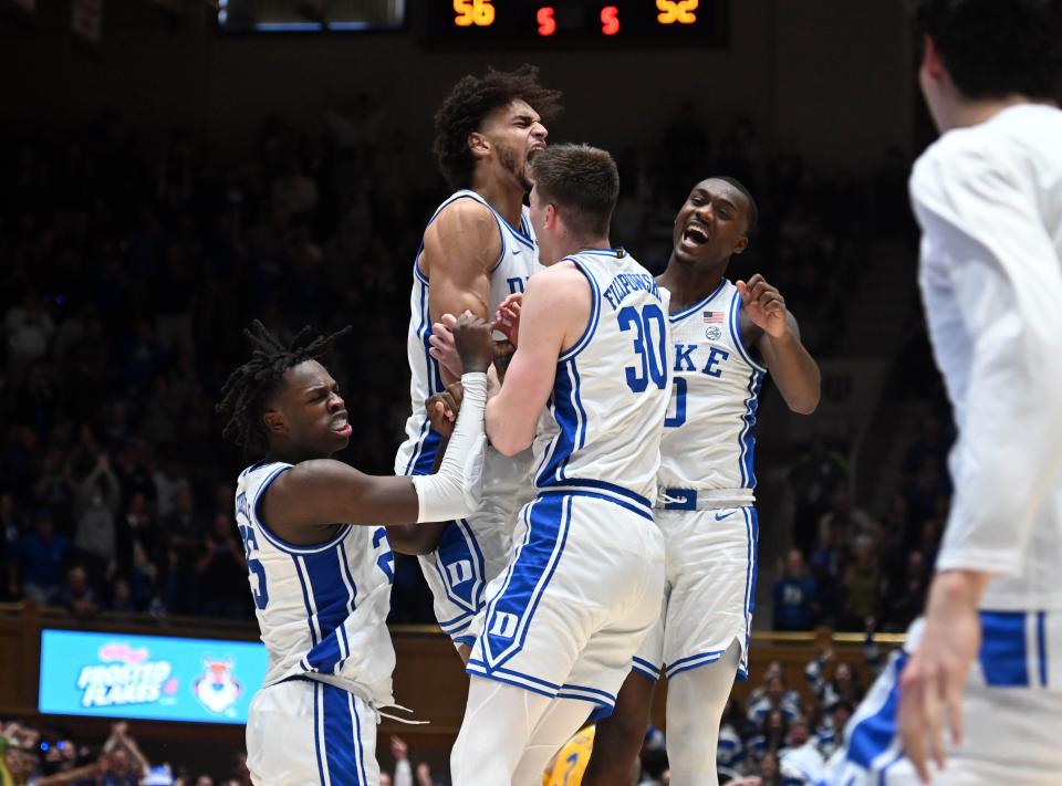 Duke players react to a basket during the second half against the Pittsburgh at Cameron Indoor Stadium.