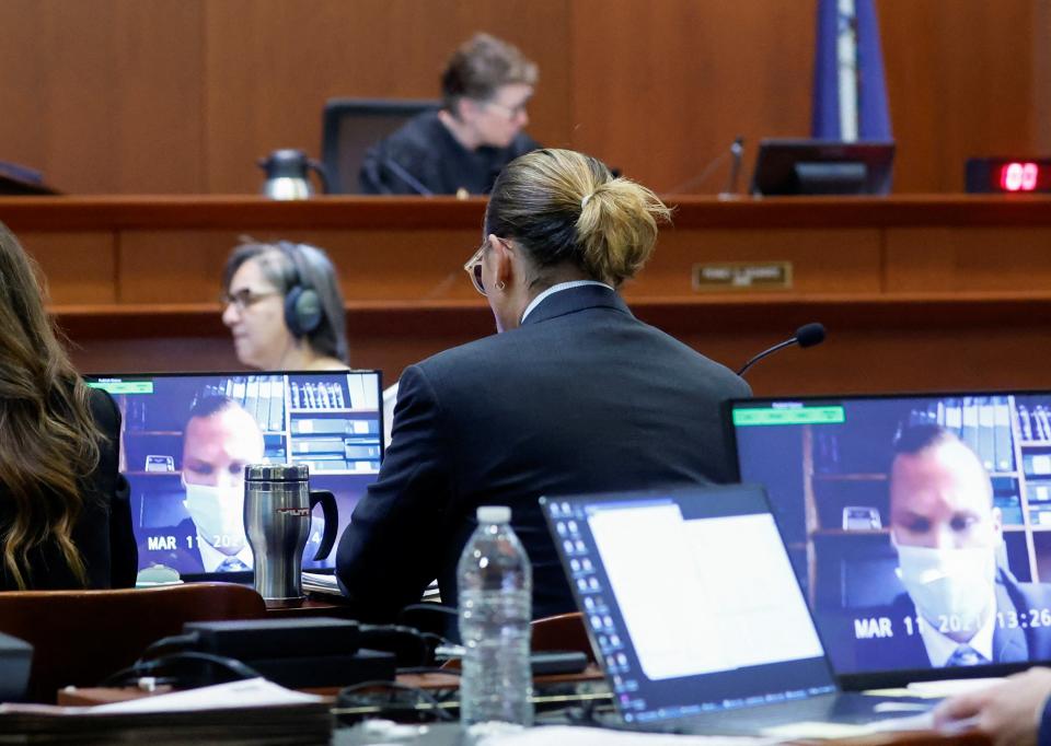 Johnny Depp watches a deposition testimony of Los Angeles Police Department officer Tyler Hadden (REUTERS)