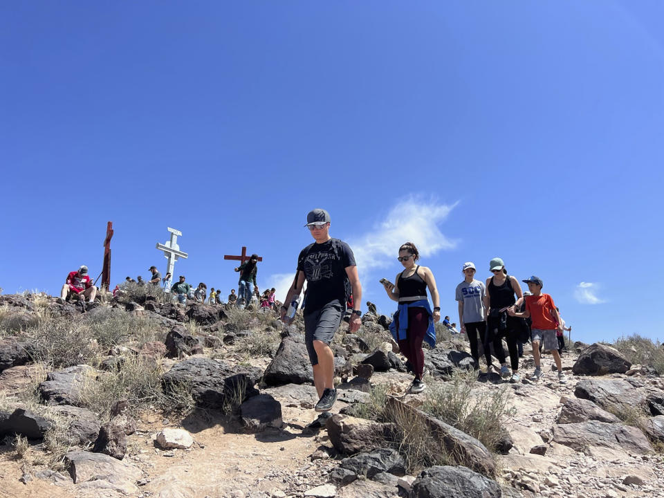 Catholic pilgrims journey to Tome Hill as part of an annual Good Friday pilgrimage, in Los Lunas, N.M., Friday, April 7, 2023. (AP Photo/Felicia Fonseca)