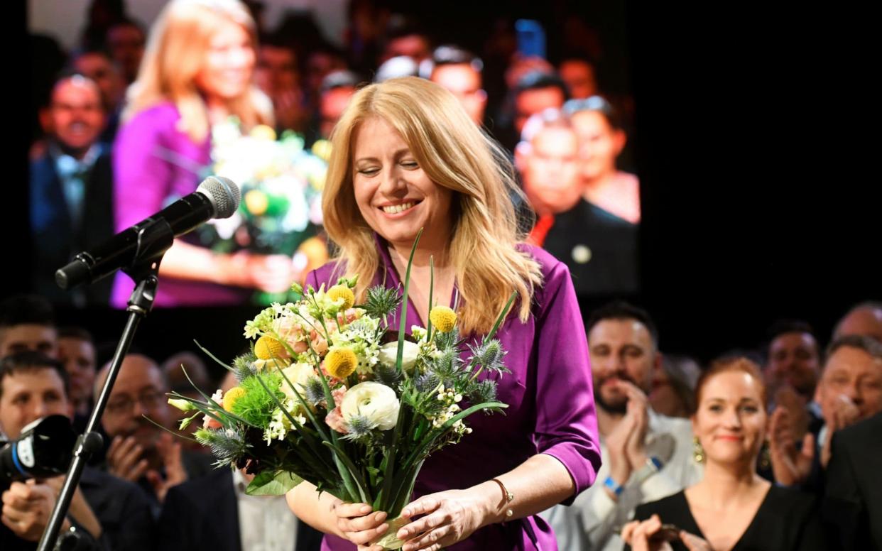 Zuzana Caputova receives flowers after winning the presidential election, at her party's headquarters in Bratislava - REUTERS