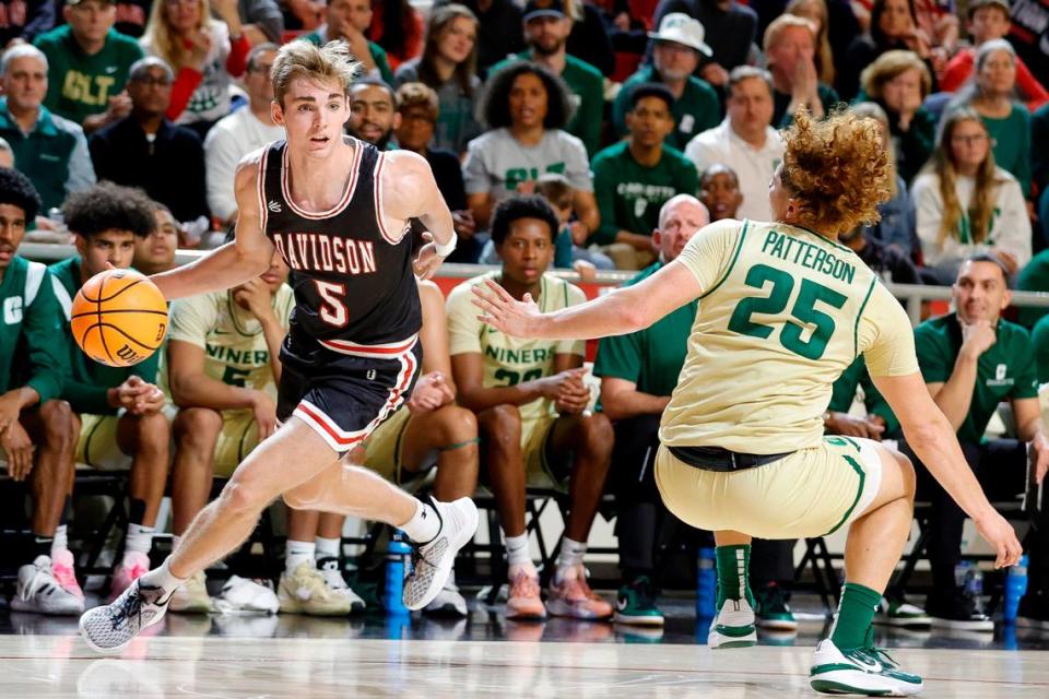 Davidson Wildcats guard Grant Huffman (5) dribbles around Charlotte 49ers guard Lu’Cye Patterson (25) during a game at Belk Arena in Davidson, N.C., Tuesday, Nov. 29, 2022.