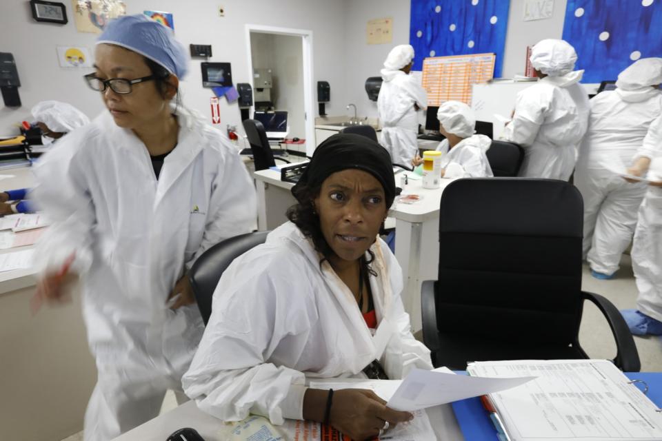 Nurse Sherron Lovelady, center, lost her father to suspected COVID-19 before coming to work at the COVID unit temporarily.