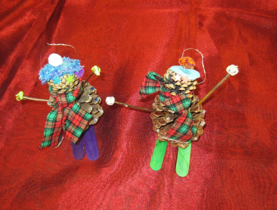 This undated publicity photo provided by Mary Cunningham shows skiers as ornaments created by the fourth-grade students of Limon Elementary School, of the small town of Limon, on the Eastern plains of Colorado, who gathered pine cones to make skiers to suit the 2012 Capitol Christmas tree campaign theme, “Celebrating Our Great Outdoors.” These handmade ornaments are among 10,000 crafted and donated by school children and other Colorado residents to the Capitol Christmas tree campaign. Some of the ornaments will adorn the 73-foot Engelmann spruce destined for the West Lawn of the U.S. Capitol while others will decorate nearly 70 smaller trees, also from Colorado, destined for government office buildings in Washington, D.C., this holiday season. (AP Photo/Mary Cunningham, Mary Cunningham)