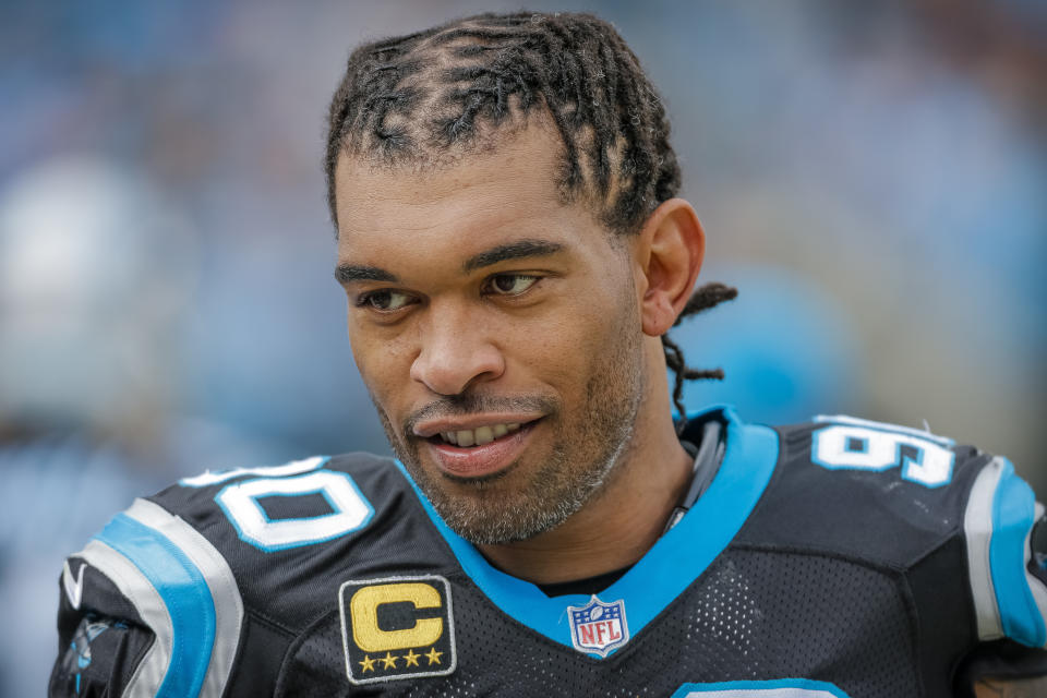 FILE - In this Dec. 24, 2017, file photo, Carolina Panthers' Julius Peppers (90) looks on from the sidelines during the first half of an NFL football game against the Tampa Bay Buccaneers in Charlotte, N.C., Dec. 24, 2017. The Carolina Panthers announced they're inducting defensive end Julius Peppers and wide receiver Muhsin Muhammad into the team’s Hall of Honor. The inductions will take place at Bank of America Stadium at halftime of the team’s Oct. 29 game against the Houston Texans.(AP Photo/Bob Leverone, File)