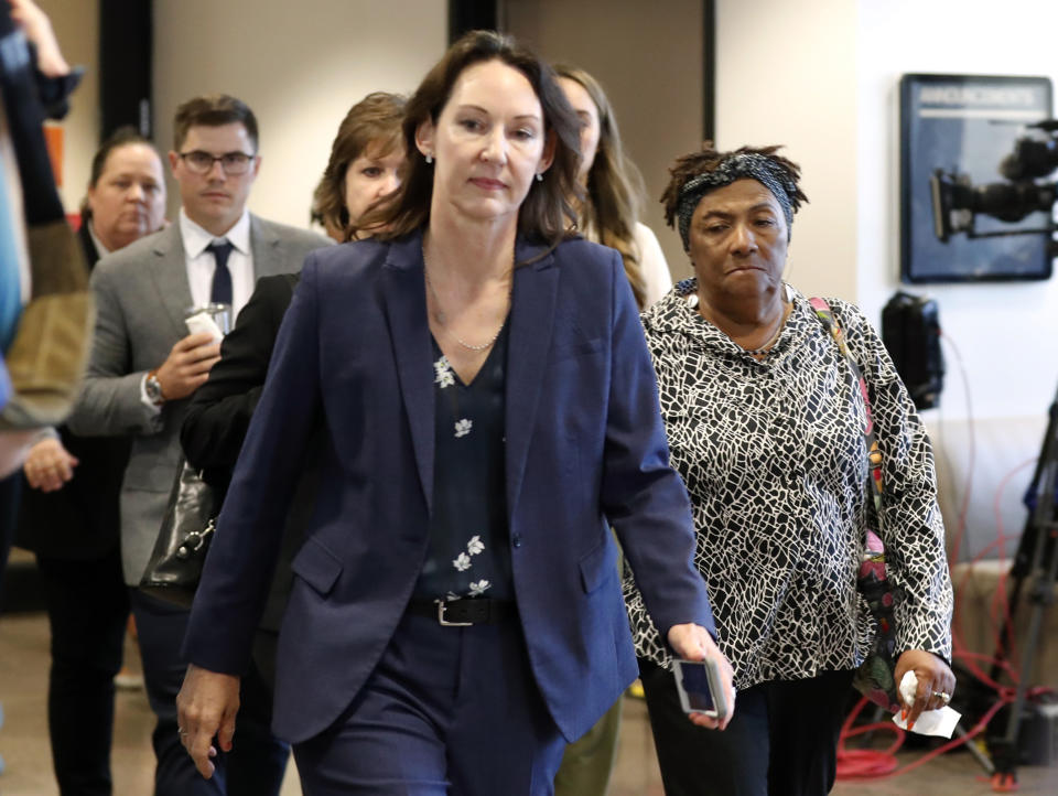Defense witness LaWanda Clark, right, leaves court during a lunch break in the punishment phase of former Dallas police officer Amber Guyger's murder trial at Frank Crowley Courts Building in Dallas, Wednesday, Oct. 2, 2019. Guyger, who said she fatally shot her unarmed black neighbor Botham Jean after mistaking his apartment for her own, was found guilty of murder the day before. (AP Photo/Tony Gutierrez)